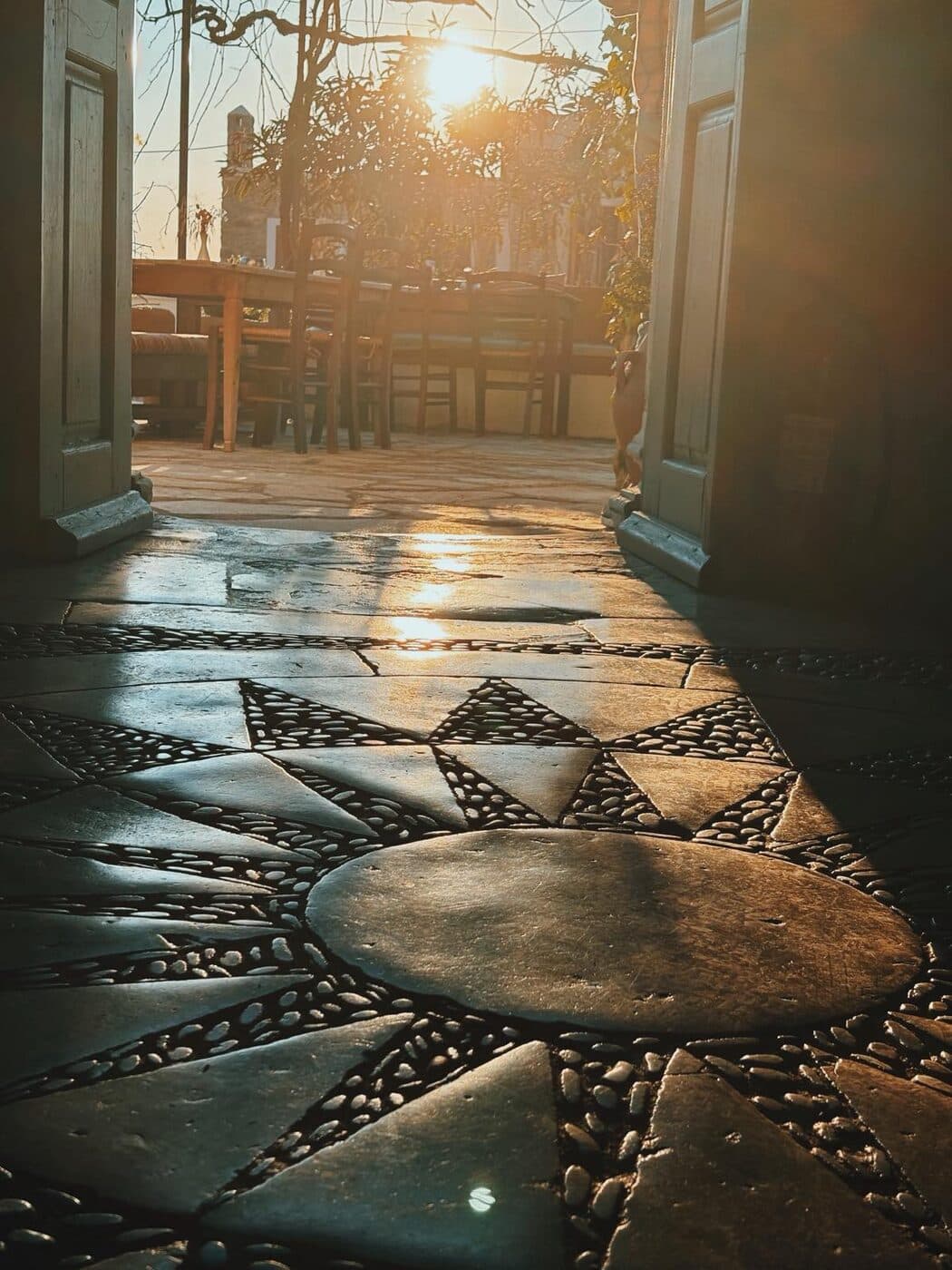 The pebble mosaic floor of the courtyard in the late sun
