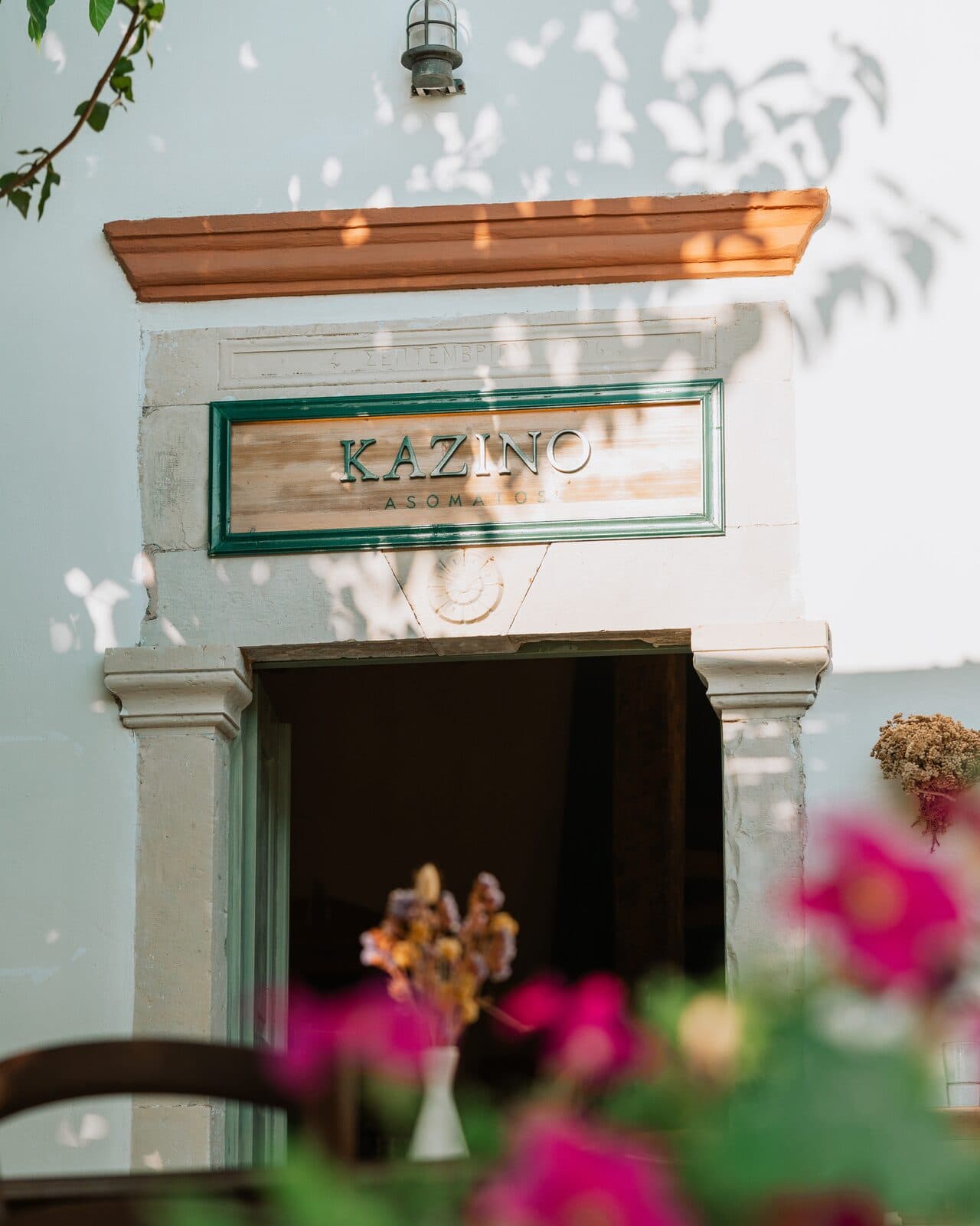 The carved Kazino sign above the doorway, dated 1906