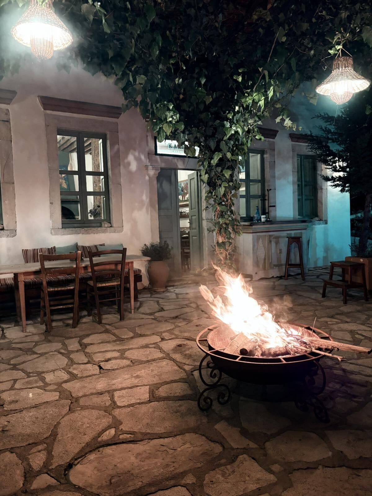 The fire pit lit in the courtyard after dark
